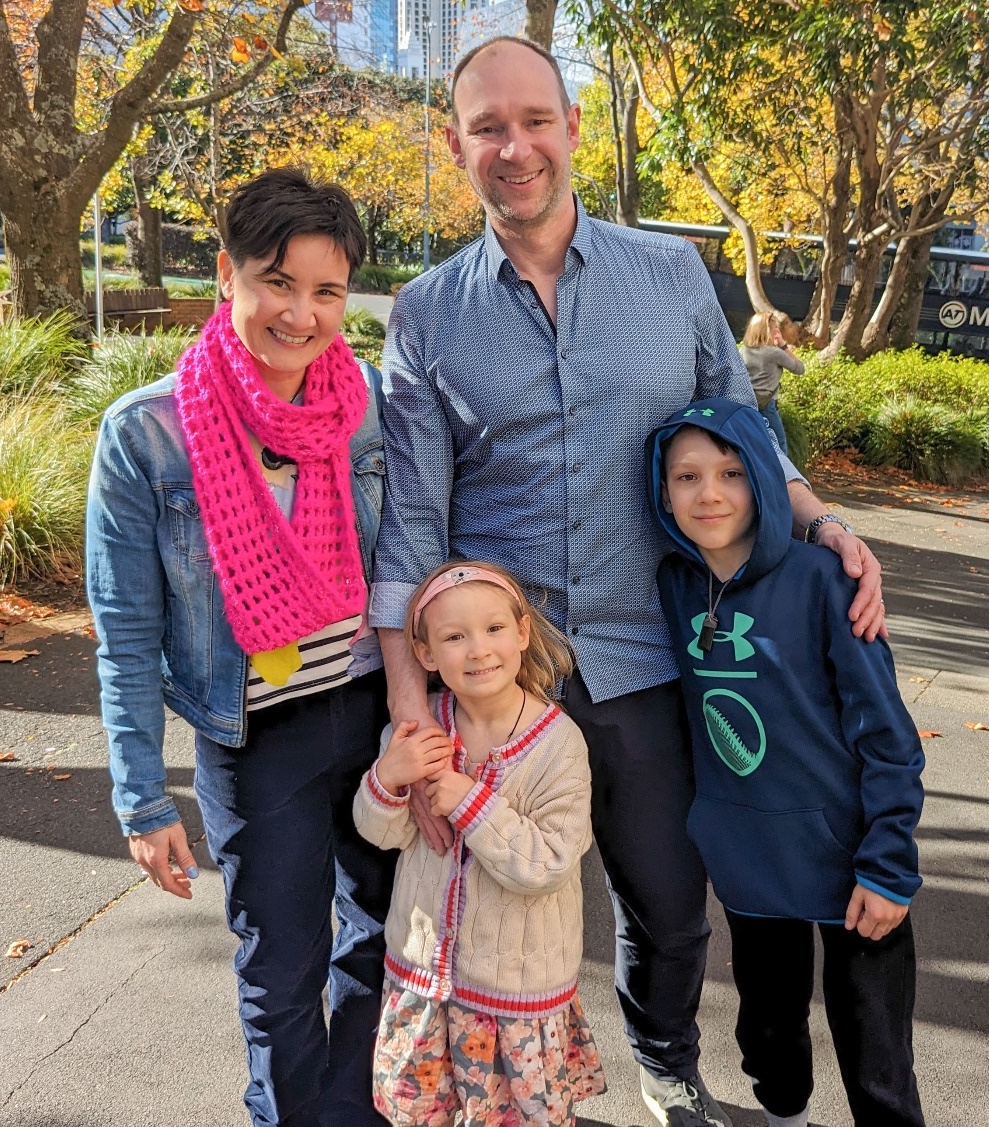 Picture of Liz in front of a sunset, smiling